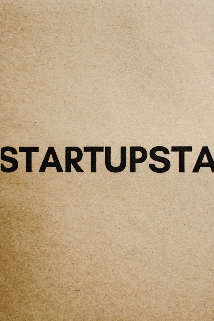 Minimalist close-up of the word startup printed on brown paper, ideal for business themes.